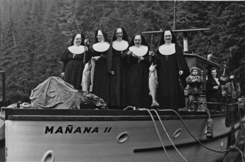 The sisters of Ketchikan holding chinook salmon on a fishing trip aboard the "Manana II" boat