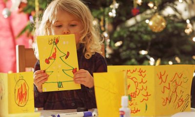 Little girl making holiday greeting cards.