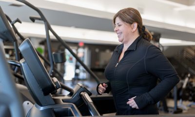 A woman smiling while exercising in the gym