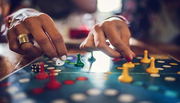 Close-up on hands playing a board game