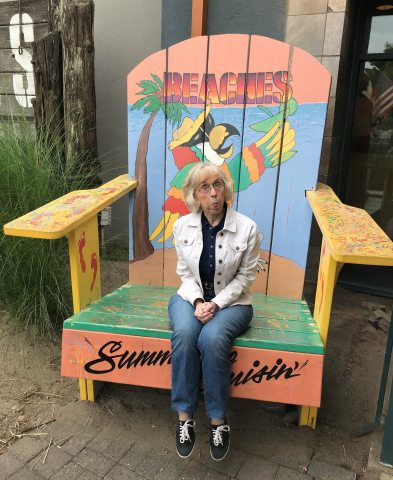 Barbe West silly pose in oversized beach chair