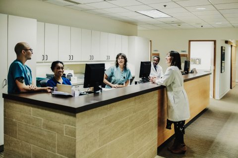 A group of caregivers talking together around a desk