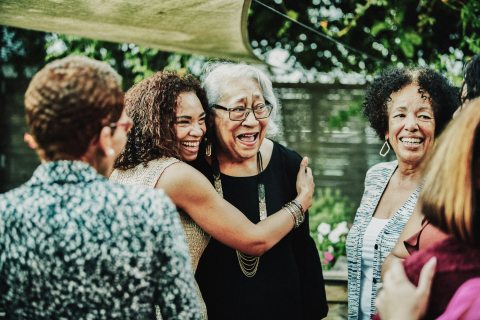 A group of women featuring two hugging