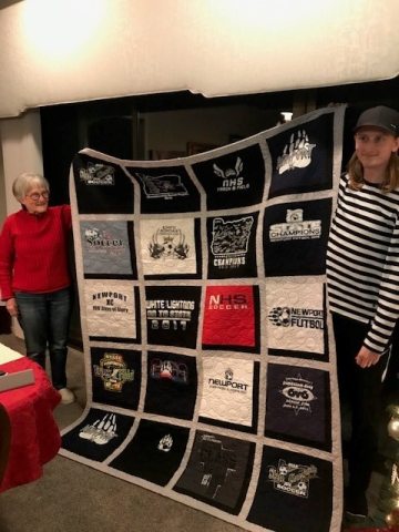 Agnes and Jakob posing with handmade quilt