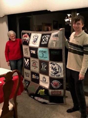 Agnes and Kolby posing with handmade quilt