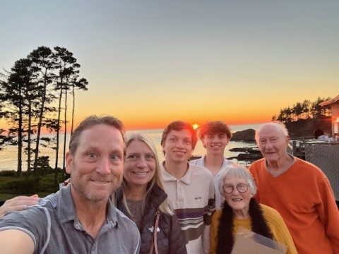 Agnes Wood and family at sunset taking a group selfie in Depoe Bay, Oregon