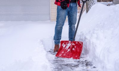 Man shovels snow from driveway