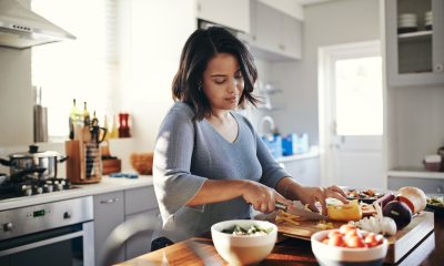 Woman making a healthy meal in her kitchen.