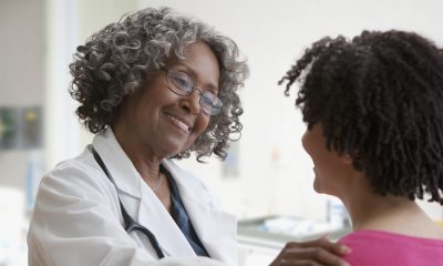 Female doctor talking with female patient.