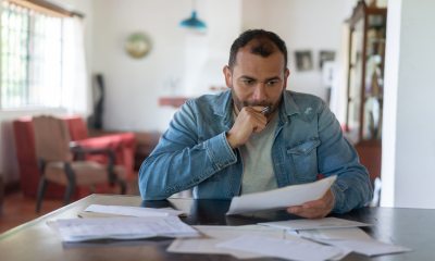 Middle-aged man studies papers at a table