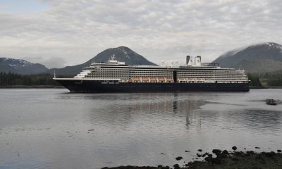 A cruise ship floating in the waters off of Ketchikan, Alaska with a cloudy gray sky in the background
