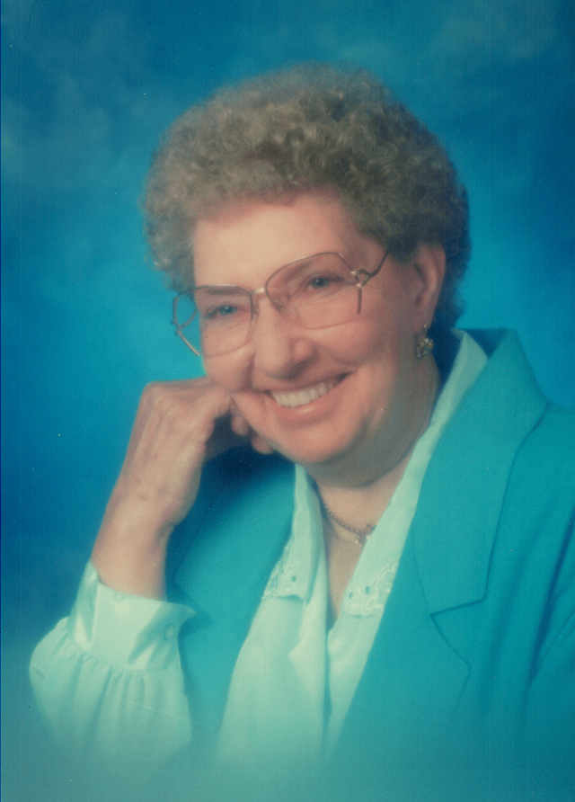 A smiling elderly woman poses for a portrait