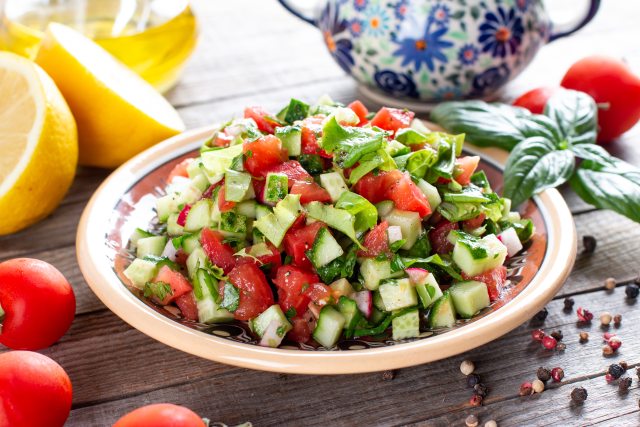 Chopped cucumber and tomato salad in a bowl.