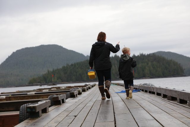 Adult and child walking on a dock