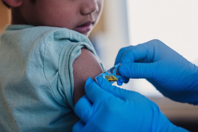 Young child getting a vaccine.